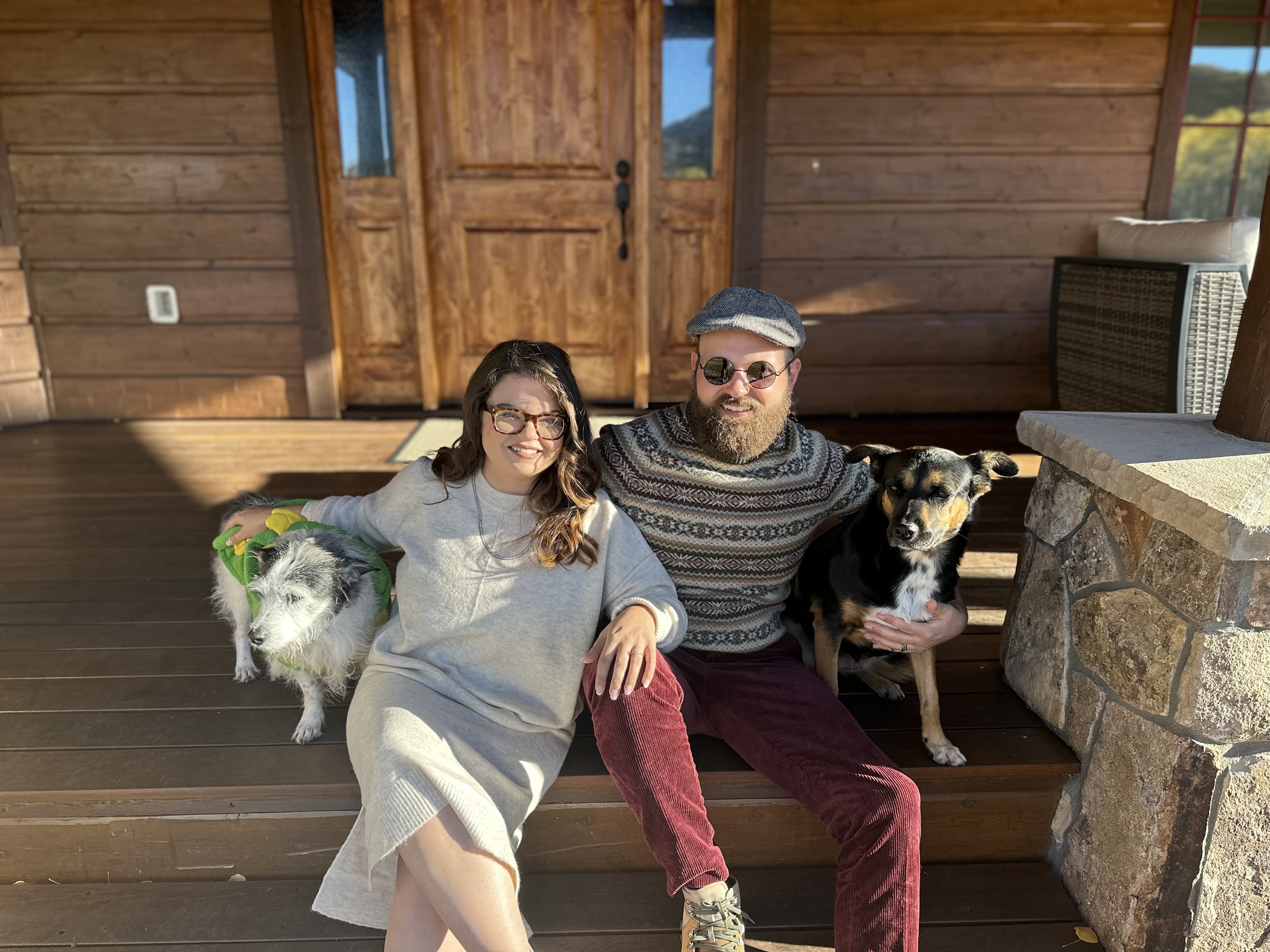 Zach Beaudoin and his wife with their dogs on the porch