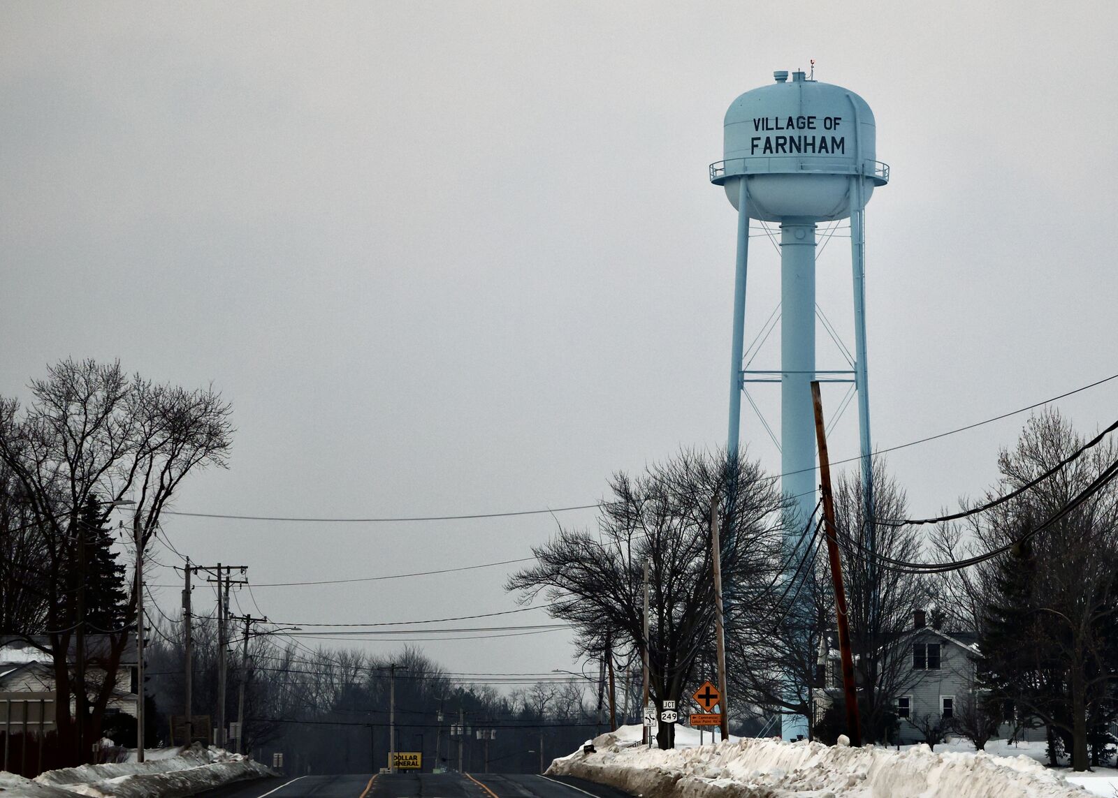 Village of Farnham water tower rising above a winter streetscape in Brant