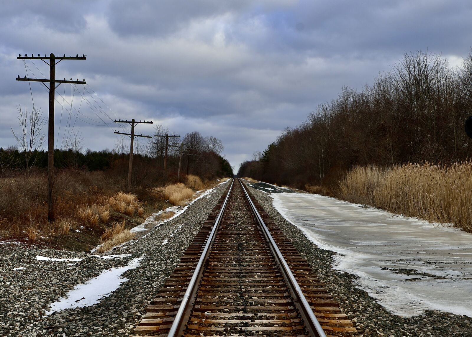 Railroad tracks stretching into the distance through rural Evans